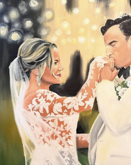 Live wedding painting on easel during reception.